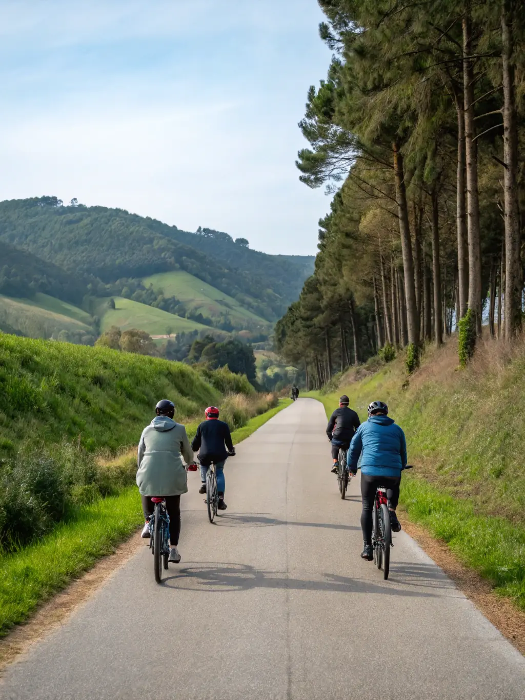 A group of cyclists enjoying a post-ride meal together outdoors, showcasing the social aspect of membership.